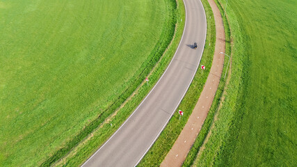 Aerial drone view of asphalt motorway road and bicycle lane from above, transportation infrastructure of the Netherlands