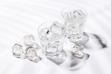 Crystal-clear glasses filled with chilled water and ice cubes