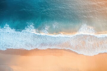 Aerial view of a tranquil beach showcasing gentle waves lapping against a golden shore, creating a serene coastal scene.
