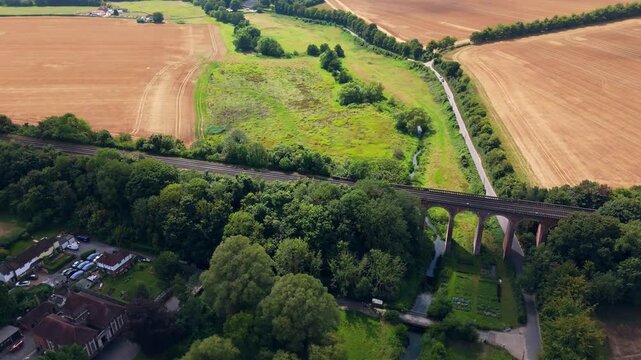 Aerial panning parallax scenery, historic viaduct structure, County Kent