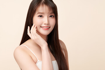 Fototapeta premium Beautiful young asian woman with clean fresh skin on beige background, Face care, Facial treatment, Cosmetology, beauty and spa, Asian women portrait.