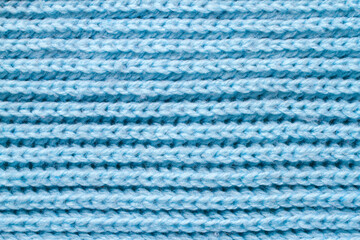 Blue wool fabric close-up. Texture of knitted fabric.