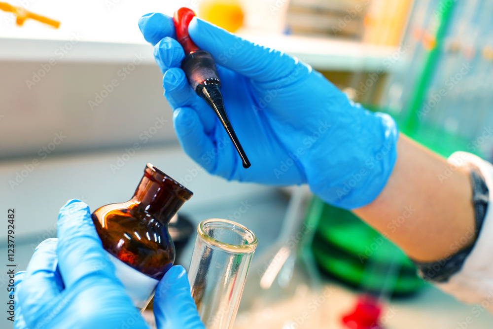 Poster lab technician conducts an experiment using pipette and glass vial in a laboratory setting during da