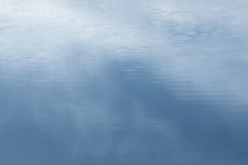 Reflection of the early dawn blue sky in the water.