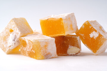 Colorful Turkish delight pieces arranged attractively on a plain background