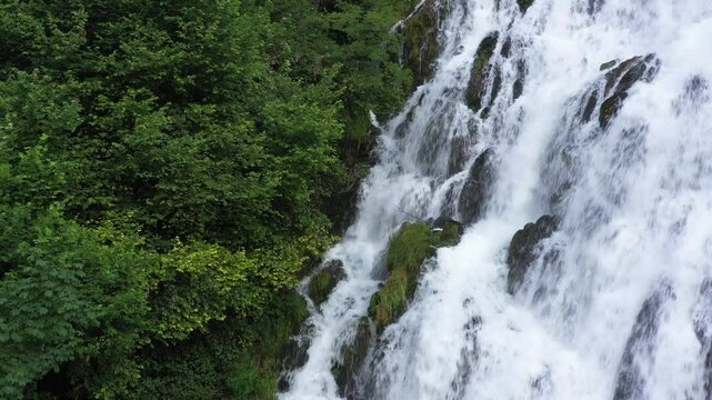 Cascading Beauty: Drone View of a White River Flowing Through the Alps