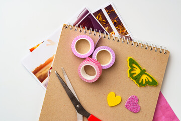 Craft supplies arranged on a table with colorful tape, scissors, and decorative paper cutouts ready...