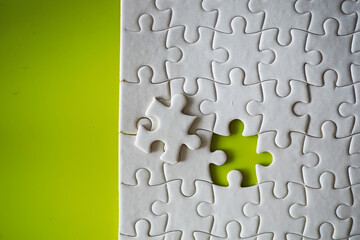 Clean puzzle elements on the background. Empty puzzle piece on the table. Teamwork concept.