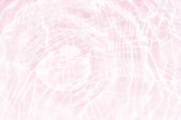 Pink water bubbles on the surface ripples. Defocus blurred transparent pink colored clear calm water surface texture with splash and bubbles. Water waves with shining pattern texture background