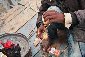 A cup of hot aromatic tea on the vintage fishing boat in Atlantic ocean, Mauritania, West Africa