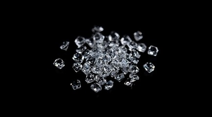 Sparkling clear ice cubes scattered on black background.