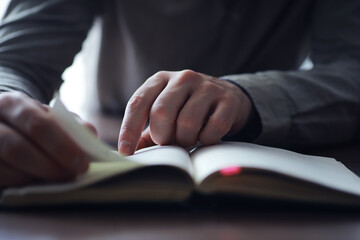 Obraz premium Read book. A man sits and reads literature. Textbooks to study. Religion.