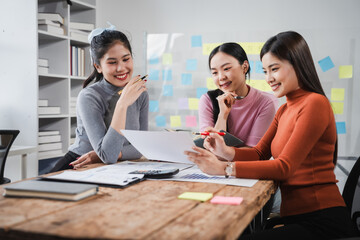 Asian people, motivated businesswoman at her desk, brainstorming creative ideas to kickstart her...
