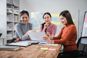 Asian people, motivated businesswoman at her desk, brainstorming creative ideas to kickstart her...