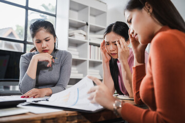 Asian people, frustrated businesswoman sits at desk, grappling with challenges of her startup, acknowledging failure, and seeking ways to learn and grow. team meeting. blamed