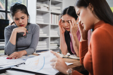 Asian people, frustrated businesswoman sits at desk, grappling with challenges of her startup, acknowledging failure, and seeking ways to learn and grow. team meeting. blamed