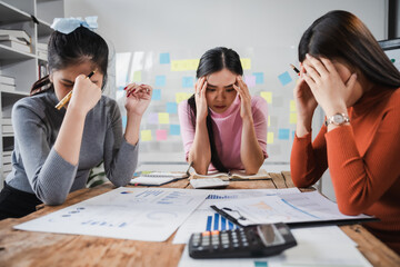 Asian people, frustrated businesswoman sits at desk, grappling with challenges of her startup, acknowledging failure, and seeking ways to learn and grow. team meeting. blamed