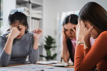 Asian people, frustrated businesswoman sits at desk, grappling with challenges of her startup, acknowledging failure, and seeking ways to learn and grow. team meeting. blamed