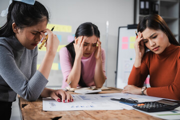 Asian people, frustrated businesswoman sits at desk, grappling with challenges of her startup, acknowledging failure, and seeking ways to learn and grow. team meeting. blamed