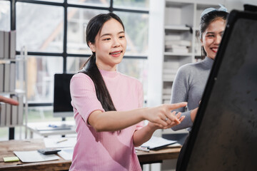 Asian people, motivated businesswoman at her desk, brainstorming creative ideas to kickstart her...