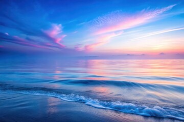 Obraz premium Serene Coastal Dawn Gentle Waves Embrace a Pastel Sky at the Water's Edge