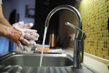 Man washing dish in sink at restaurant.People are washing the dishes too Cleaning solution