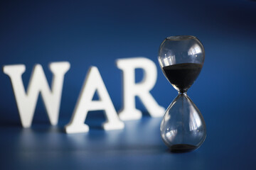 WAR, word written in wooden alphabet letters on blue background. The concept of a terrible war...
