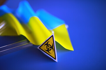 Ukrainian flag biohazard and test tubes. Assistance to Ukraine in biolaboratories. Western...