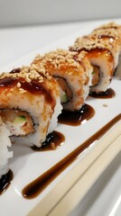 A plate of sushi with a sauce on it. The sushi is rolled up and has a lot of sauce on it