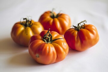Obraz premium A photo of orange ripe tomatoes on a white background