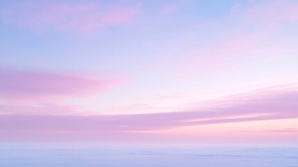 Obraz premium A serene sunset sky with soft pink and blue hues, creating a tranquil atmosphere.