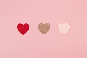 Happy Valentine's Day. Top view of colorful hearts on pink background. Pink glitter hearts, red hearts, pink hearts, love wallpaper. Flat lay, copy space.