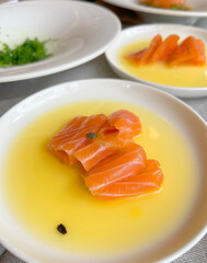 Sashimi in mango juice on plate. Salmon slices. Seafood and Asian cuisine. Healthy foods and longevity. 