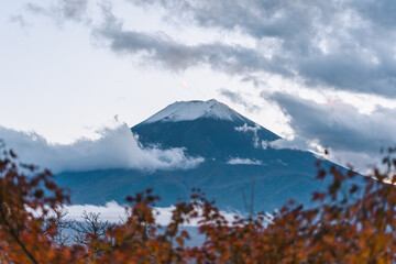 Snow-covered Fuji mountains with a beautiful autumn sunset landscape and cloudy sky