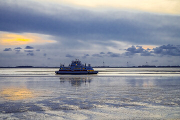 Landscape near Dagebüll in the evening. Nature on the North Sea coast with a ferry.
