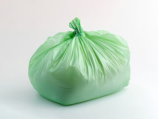 Biodegradable green garbage bag on white floor.