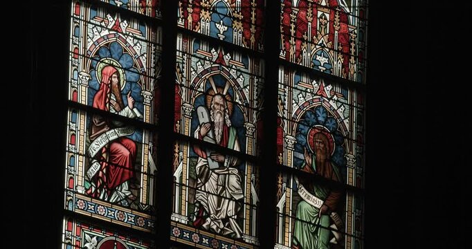 depiction of ten commandments in stained glass window