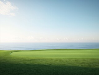 Smooth green grass field meeting the blue ocean.