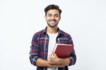 male student holding a book to her chest. Education, learning, knowledge, student life concept.