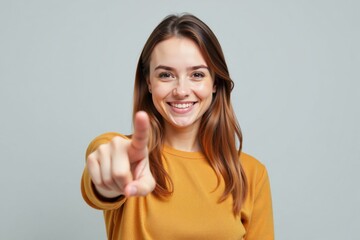A cheerful woman pointing forward with a smile, symbolizing confidence, direction, and optimism.