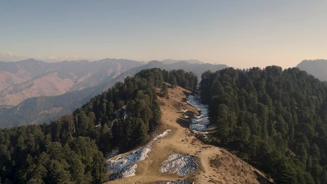 View of the ancient Moila Top in Chakrata, with a lush green mountain trail winding through rocky terrain, offering breathtaking vistas of nature. Moila Danda, Chakrata, Uttarakhand, India.