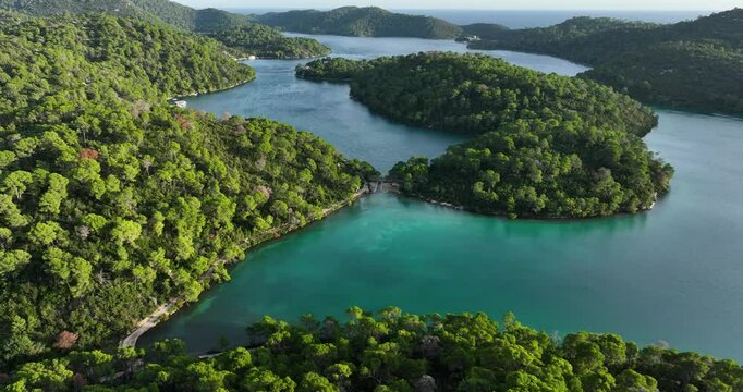 Mljet National Park landscape with vibrant green trees, Mali most stone bridge in view, Drone view