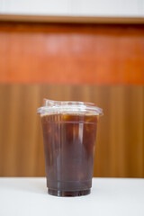 Closeup of take away plastic cup of iced black coffee Americano