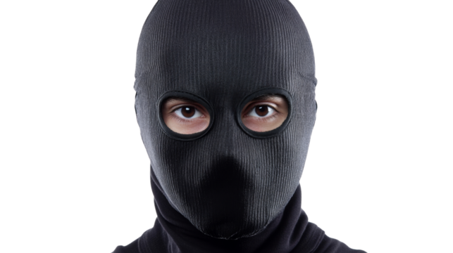 Thief wearing black balaclava is staring on transparent background