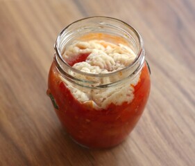 Mould and fungus on homemade canned tomato and pepper salsa sauce. An example of poorly preserved vegetables.