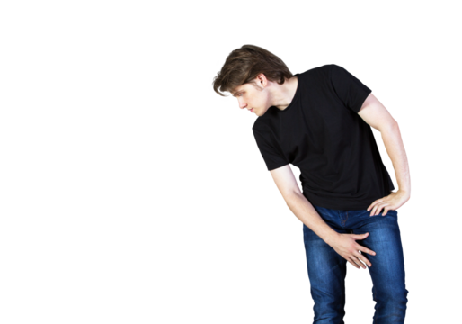 A man in ashirt and blue jeans leaning forward and looking sideways, isolated on a white background. Concept of curiosity or observation