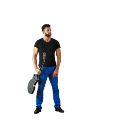 Man holding an acoustic guitar, wearing ashirt and blue pants, standing confidently on a white background, concept of style and music