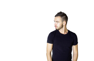 Fototapeta premium Young man with a neat hairstyle and beard wearing ashirt, standing and looking to the side on a clean white background