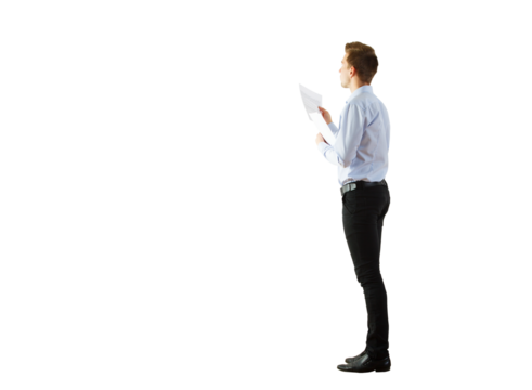 Man in casual office attire holding a paper, standing sideways. Isolated on a clean white background. Concept of business, reading, or analysis