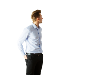 Young man in light blue shirt andpants looking to the side, hands in pockets. Isolated on white background. Concept of casual style